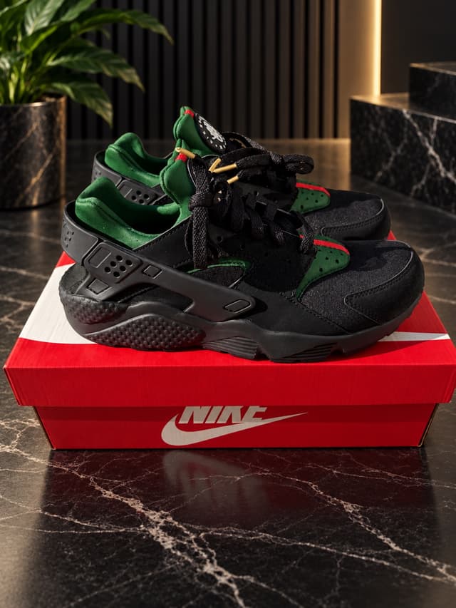 Black custom painted Nike Air Huaraches on their original box
